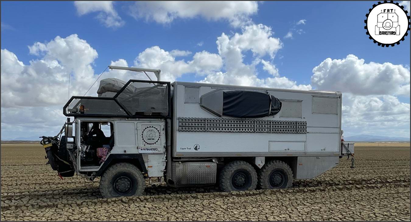 MAN KAT1 6x6 expedition truck driving through mud during overland expedition