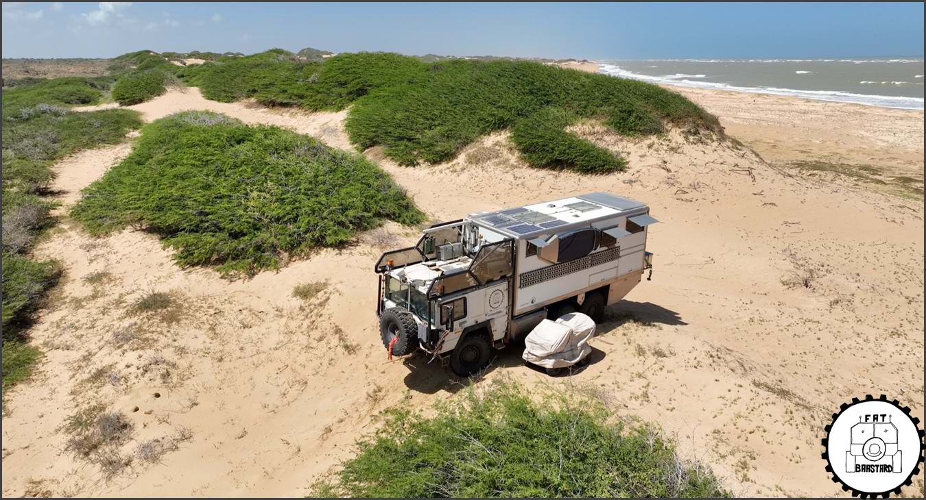 MAN KAT1 6x6 expedition truck parked on remote beach during overland journey